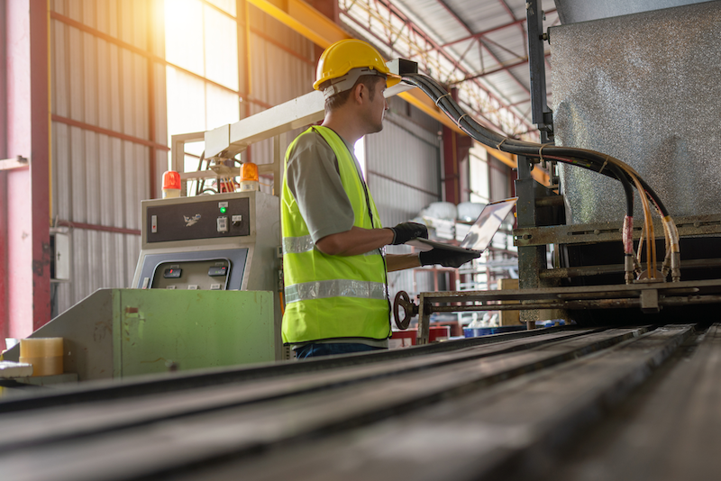 Manufacturing worker awaiting urgent delivery to prevent downtime