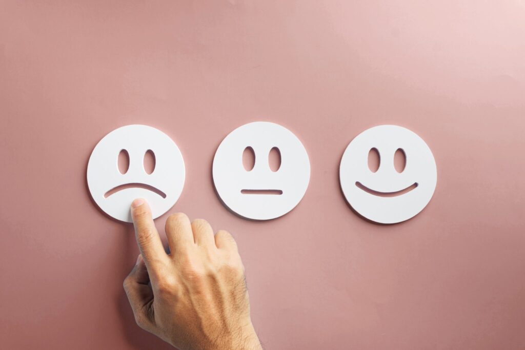 Hand selecting a sad face rating, representing the cost of being unprepared for peak season freight demand